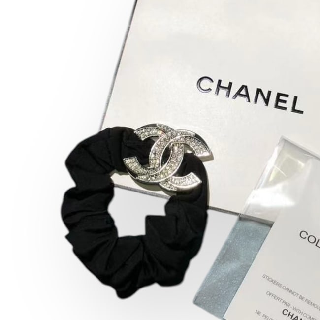 CHANEL Silver/White Rhinestone CC L.A. Collection Scrunchy & Original Gift Bag: • CHANEL • Gabrielle • Scrunchy/Hair Tie • Silver Tone Hardware • White Rhinestone CC Logo • CC Logo • Black Scrunchy • CC Shaped • L.A Collection • U