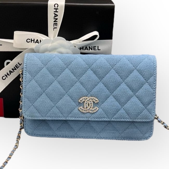 CHANEL Quilted Blue/Rhinestone CC Wallet On Chain Beaute Bag & Original Box: • CHANEL • Blue • Denim • Quilted Pattern • Wallet On Chain (WOC) • Silver Tone Hardware • Intertwined Leather Chain Strap • Snap Closure • Front Rhineston