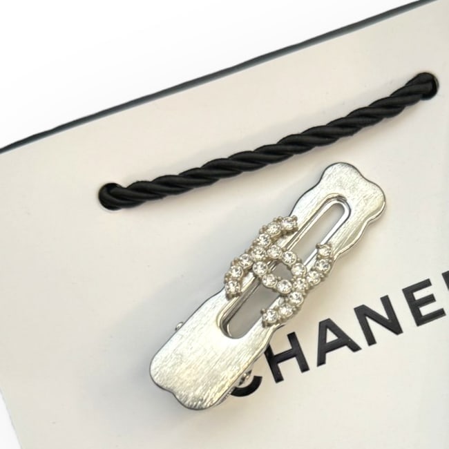 CHANEL Silver/White Rhinestone CC Rectangle Hair Clip & Original Gift Bag: • CHANEL • L.A. Collection • Gabrielle • Hair Clip • White Rhinestone CC Logo • Silver Tone Hardware • Shape: Rectangle • Unopened/In Original Packaging •