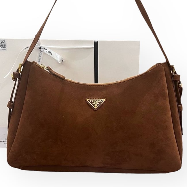 Prada Brown/Gold Aimée Beaute Shoulder Bag & Original Gift Bag: • Prada • Aimee • Brown • Gold Tone Hardware • Front Logo • Single Strap • Zip Closure • Interior Slip Pocket • Original Gift Bag Included • 15.8" x 9