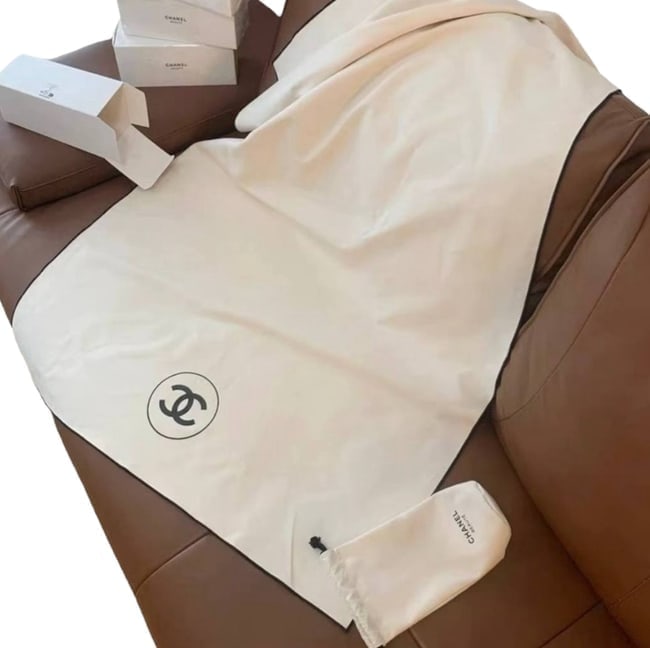 CHANEL White/Top Logo Beaute Towel Blanket & Storage Pouch: • CHANEL • Throw Blanket • White • Black Accents • Front Logo • Storage Pouch Included • Original Box Included • 51.1" x 31.5" (in) • Makeup/Diffusion Line