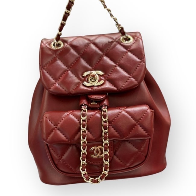 CHANEL Deep Red Quilted Mini Beaute Backpack & Gift Bag: • CHANEL • Deep Red • Duma Backpack • Quilted Pattern • Front CC Logo • Gold Tone Hardware • Signature CC Twist Lock Closure • Front Exterior Snap Pocket &bul