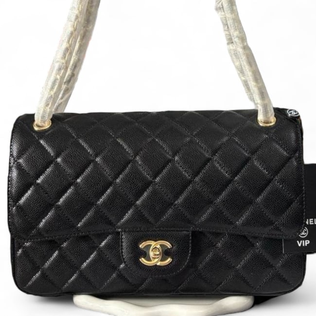 CHANEL Jumbo Black Quilted Classic Flap Beaute Bag & Gift Bag: • CHANEL • Classic Flap • Jumbo • Black • Quilted Pattern • Gold Tone Hardware • Front CC Twist Lock Closure • Interior Slip Pocket • Intertwined Leather C