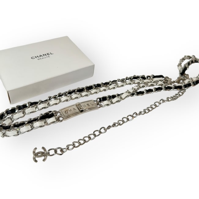 CHANEL Silver/Black & White Intertwined Chain Strap Beaute Belt & Gift Bag: • CHANEL • L.A. Collection • Belt • Adjustable • Silver Tone Hardware • Black & White Intertwined Chain Strap • Front CHANEL Logo • CC Logo Charm • Origina