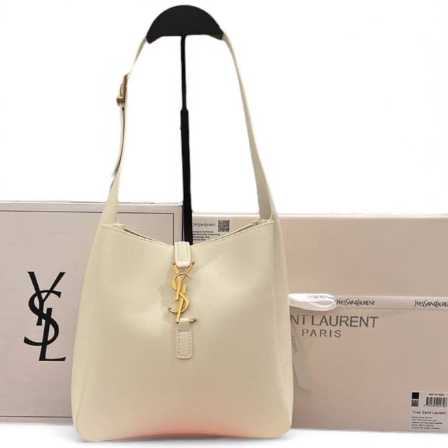 YSL Saint Laurent White/Gold Beaute Bucket Bag & Original Box: • YSL Saint Laurent • Bucket Bag • White • Gold Tone Hardware • Front YSL Logo • Adjustable Strap • Single Strap • Shoulder Or Arm Carry • 8.7" x 8.3