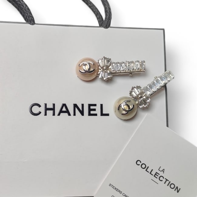 CHANEL2Pc Lg Hair Clips Pearl Detailed/Rhinestone Covered & Original Gift Bag: • CHANEL • L.A. Collection • Gabrielle • 2Pc Set • Hair Clips • Pearl Accents • Rhinestone Covered • Rhinestone Bow Detail • Metallic Silver CC Logo •