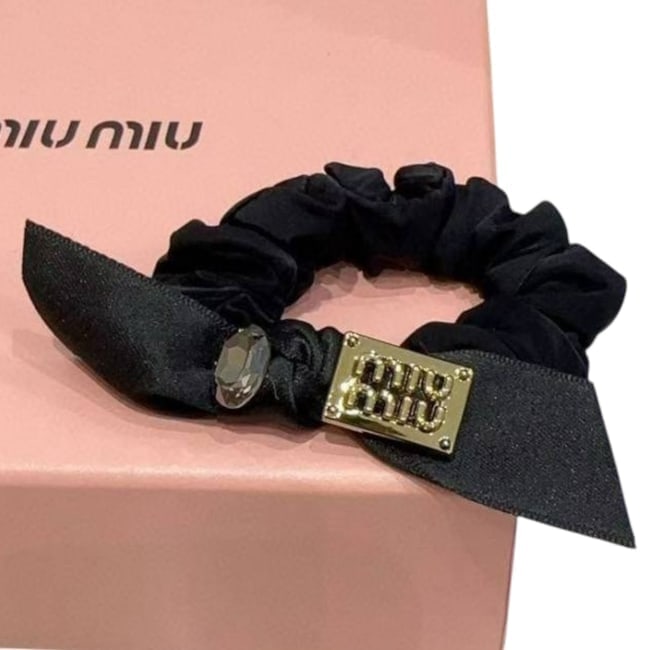 Miu Miu Black/Stone & Logo Decorated Beaute Hair Scrunchy & Original Box: • Miu Miu • Hair Scrunchy/Tie • Black • Gold Tone Hardware • Stone & Logo Decorated • Bow Detail • Scrunchy Color: Black