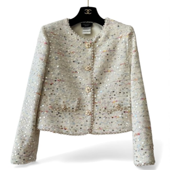 CHANEL White Tweed/Multicolor Sequin Button Up U.L Jacket: • CHANEL • Women’s • Uniform Line • White • Jacket • Tweed Material • Multicolor Sequin Detail • Pearl Accents • Front Pockets • Long Sleeve •