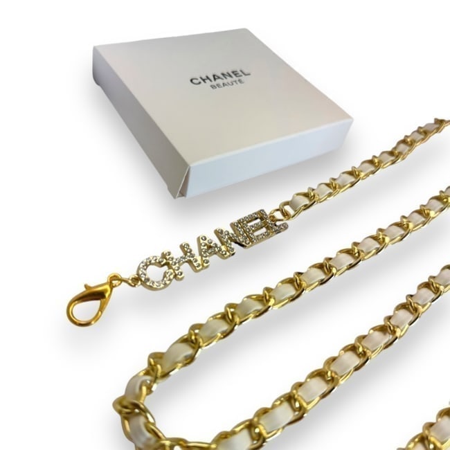 CHANEL Belt Adjustable White/Gold Rhinestone Covered CHANEL Logo Beaute Belt: • CHANEL • Belt • Gold & White Intertwined Leather Chain • Gold Tone Hardware • Adjustable • Rhinestone Covered Logo • CC Charm On End • Original Gift Bag Inclu