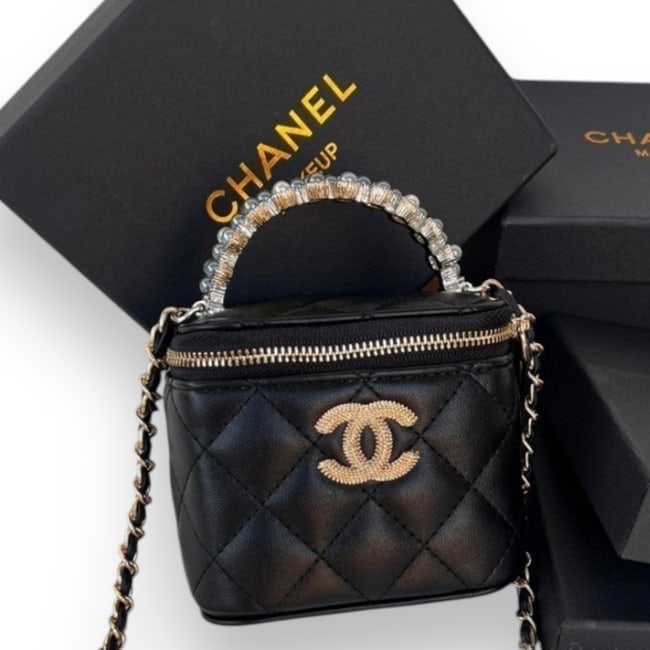 CHANEL Black Pearl Accented Mini Cube Vanity Beaute Case & Original Box: • CHANEL • Black • Quilted Pattern • Cube Vanity Case • Gold Tone Hardware • Beveled Front CC Logo • Pearl Accented Top Handle • Intertwined Leather Chain Strap