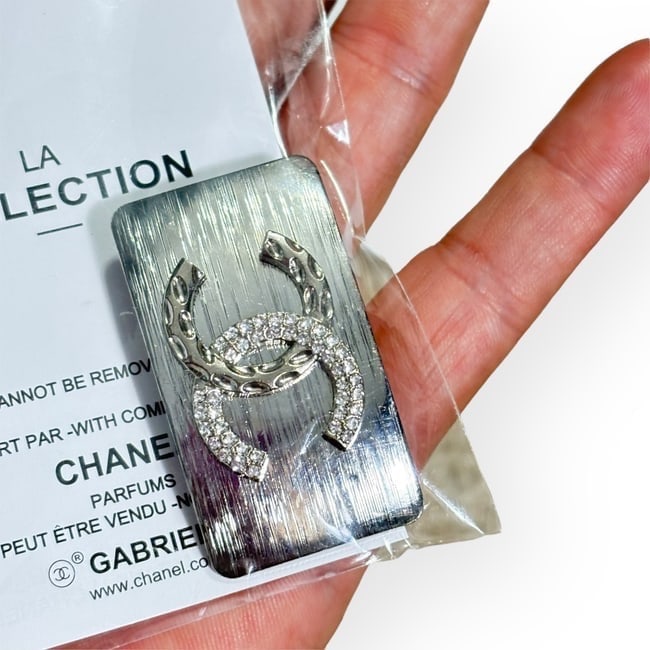 CHANEL Silver/Rhinestone Detailed CC Wide Rectangle Hair Clip: • CHANEL • L.A. Collection • Gabrielle • Hair Clip • White Rhinestone/Detailed CC Logo • Silver Tone Hardware • Wide Rectangle • Unopened/In Original Packaging