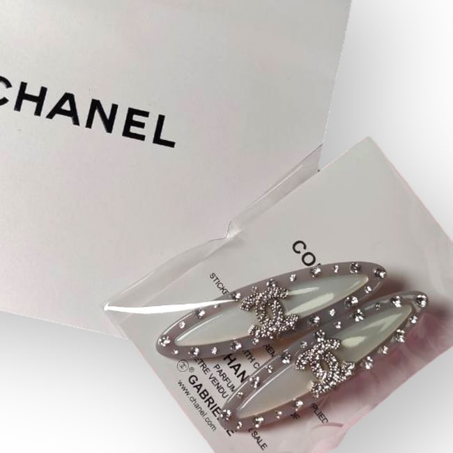 CHANEL 2Pc Lg Silver/Rhinestone CC Logo Beaute Hair Clips & Gift Bag: • CHANEL • Style: Gabrielle • Collection: L.A. Collection • Type: Hair Clips • Set: 2Pc Set • Color: Silver • Detail: Rhinestone CC Logo • Accents: Rhinestone A