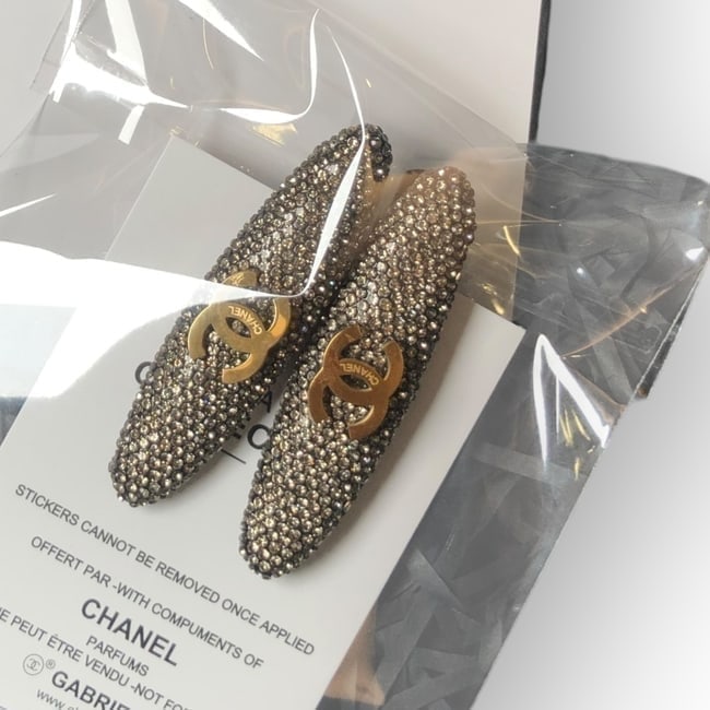 CHANEL 2Pc Gold Rhinestone/CC Long Oval Hair Clips & Gift Bag: • CHANEL • L.A. Collection • Gabrielle • 2Pc Set • Hair Clips • Gold Rhinestone • Gold CC Logo • Black Tone Hardware • Shape: Long Oval • O