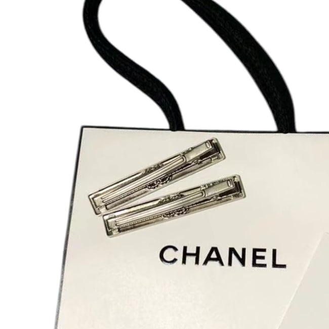 CHANEL 2Pc Silver/Rhinestone CC Hair Clips & Gift Bag: • CHANEL • Gabrielle • Hair Clips • 2Pc Set • Silver Tone Hardware • White Rhinestone CC Logo • Black CHANEL Logo • Shape: Rectangle • L.A Collection