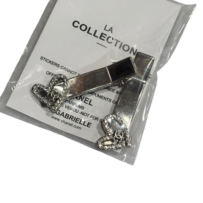 CHANEL 2Pc Set Silver/Rhinestone Heart Rectangle Hair Clips & Gift Bag: • CHANEL • L.A. Collection • 2Pc Set • Gabrielle • Hair Clips • Shape: Rectangle • White Rhinestone Heart Accents • Silver Tone Hardware • Unopened/In Orig