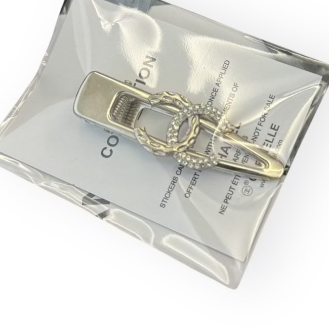 CHANEL Silver/White Rhinestone CC Hair Clip& Gift Bag: • CHANEL • Gabrielle • Hair Clip • White Rhinestone/Detailed CC Logo • Silver Tone Hardware • L.A Collection • Unopened/In Original Packaging • CHANEL Gift Bag