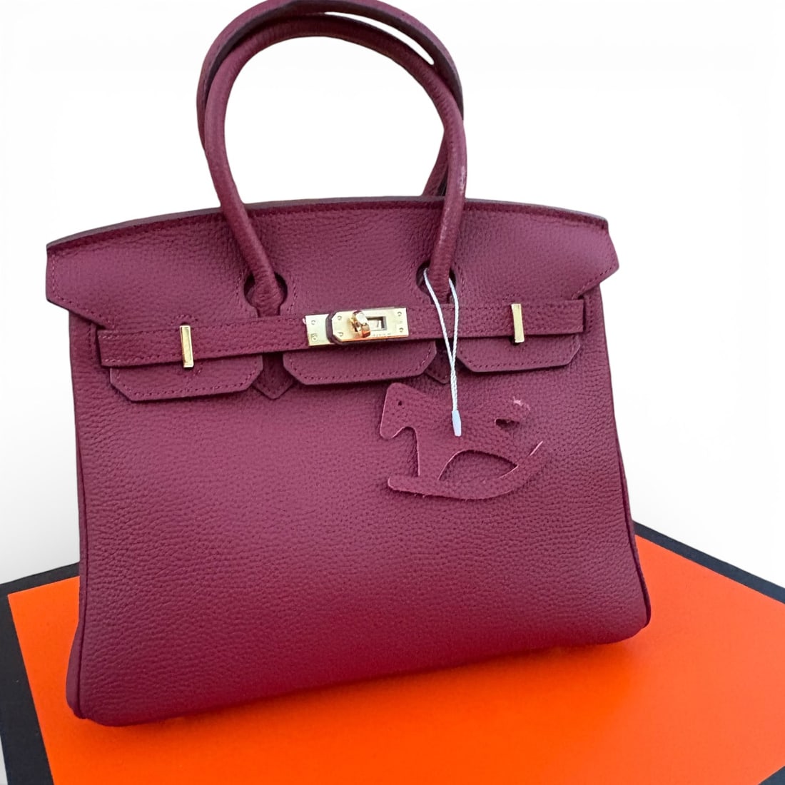 Hermes Berry/Gold Birkin Beaute Bag, Keys, & Original Box: • Hermes • Berry • Top Handle Or Shoulder Carry • Birkin Bag • Signature Front Twist Closure • Gold Tone Hardware • Zip Closure On Sides • Interior Slip Pocket