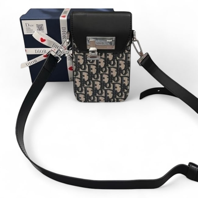 Christian DIOR Oblique Jacquard Vertical Beaute Clutch & Box: • Christian DIOR • Black/Oblique Jacquard • Vertical Clutch • Silver Tone Hardware • Adjustable/Removable Strap • Front Lock Closure • 8" x 5" (in) • Internal S