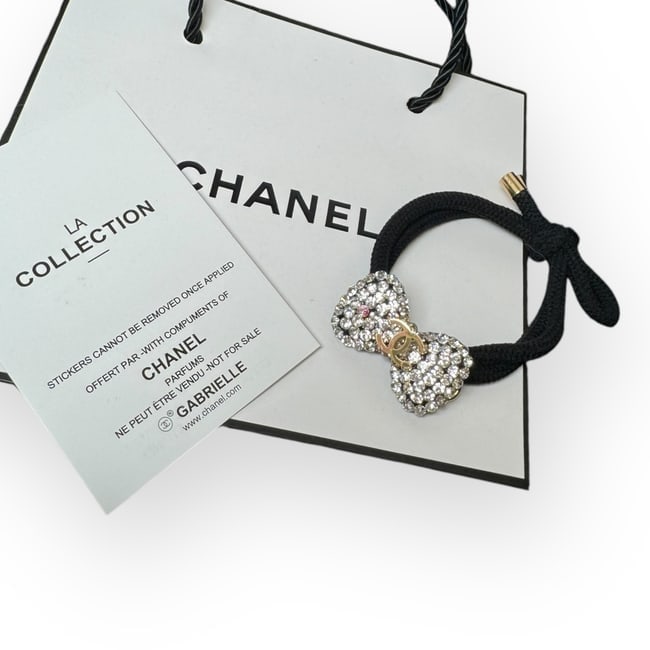 CHANEL White Rhinestone Gold CC Hair Bow Shaped Hair Tie & Gift Bag: • CHANEL • L.A. Collection • Gabrielle • Hair Tie • White Rhinestone Covered • Shape: Hair Bow • CC Logo • Unopened/In Original Packaging • Original