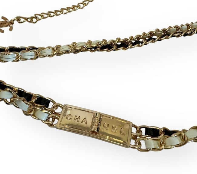 CHANEL Gold/Black & White Intertwined Leather Chain Strap Beaute Belt & Gift Bag: • CHANEL • Type: Adjustable Belt • Hardware: Gold Tone • Strap: Black & White Intertwined Leather Chain Strap • Logo: Front CHANEL Logo • Charm: CC Logo Charm • Leng