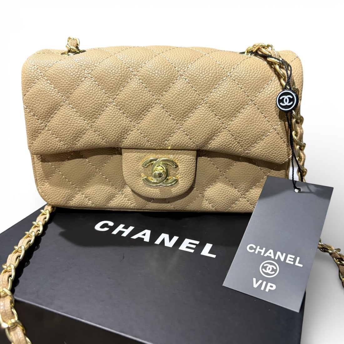 CHANEL Quilted Camel Pebbled Leather Mini Flap Beaute Bag & Original Box: • CHANEL • Color: Camel • Classic Flap Bag • Gold Tone Hardware • Quilted Pattern • Pebbled/Caviar Pattern • Signature CC Twist Lock Closure • Intertwined Leath