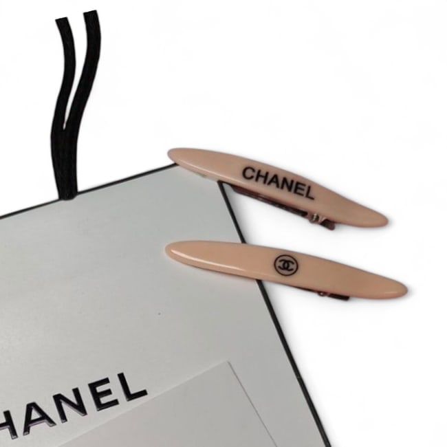 CHANEL 2Pc Peach/Long Skinny Beaute Hair Clips & Gift Bag: • CHANEL • Style: Gabrielle • Set: 2Pc Set • Type: Hair Clips • Color: Peach • Accents: Black Accents • Shape: Long Skinny • Size: Large • Collection: L.A
