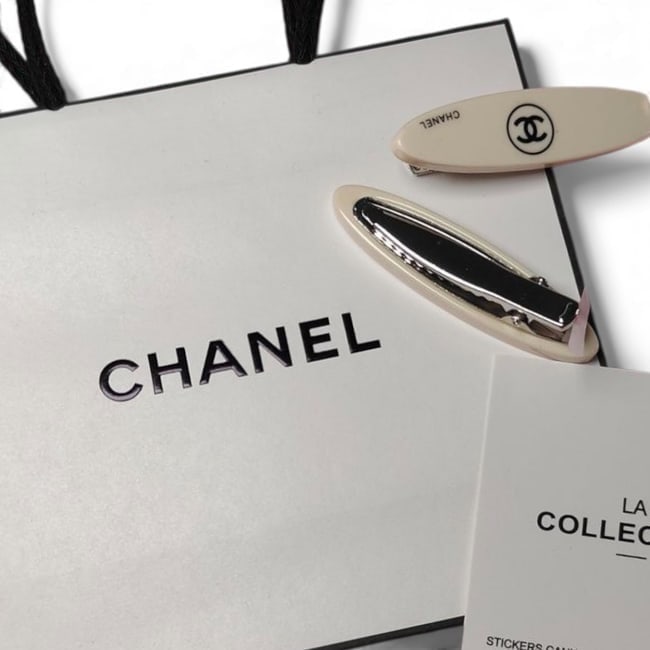CHANEL 2Pc Cream/Black CC Long Oval Beaute Hair Clips & Original Gift Bag: • CHANEL • Set: 2Pc Set • Style: Gabrielle • Collection: L.A. Collection • Type: Hair Clips • Color: Cream • Accents: Black Accents • Logo: CC Logo • Hardw