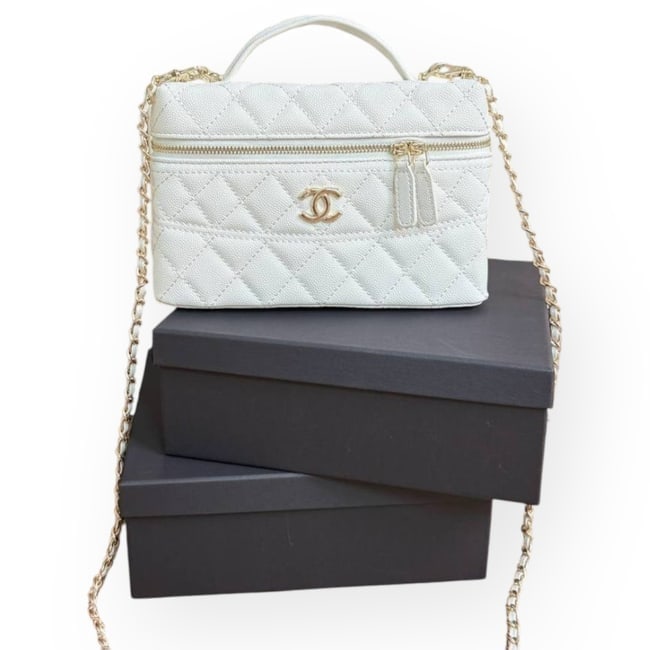 CHANEL White/Gold Quilted Front Logo Long Vanity Beaute Case & Original Box: • CHANEL • Long Vanity Case • White • Quilted Pattern • Gold Tone Hardware • Intertwined Leather Chain Strap • Zip Closure • Front CC Logo • Top Handle Or