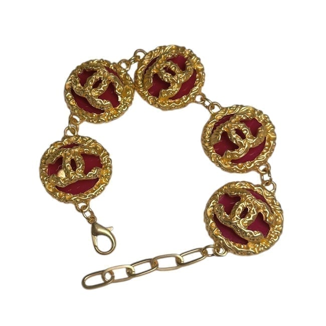 CHANEL Gold/Red Adjustable CC Logo Beaute Bracelet: • CHANEL • Type: Bracelet • Feature: Adjustable • Hardware: Detailed Gold Tone Hardware • Accents: Red Accents • Logo: CC Logo • Packaging: Original Box Included &bu