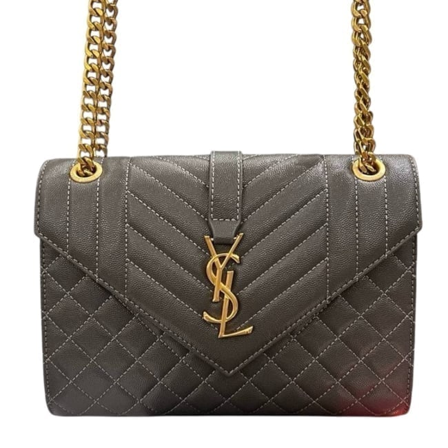 YSL (Saint Laurent) Black/Gold Quilted Envelope Shoulder Beaute Bag & Dust Bag: • YSL (Saint Laurent) • Color: Black • Hardware: Gold Tone • Pattern: Quilted • Detail: Chevron Pattern Detail • Closure: Magnetic Snap Closure • Style: Envelope Sho