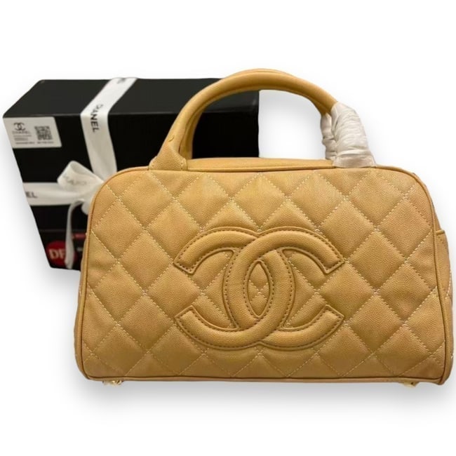 CHANEL Quilted Camel Front Logo Beaute Bowler & Original Box: • CHANEL • Color: Camel • Gold Tone Hardware • Quilted Caviar Pattern • Bowler Bag • Dust Bag Included • Top Handle Carry • Double Handles • Zip Closure <b