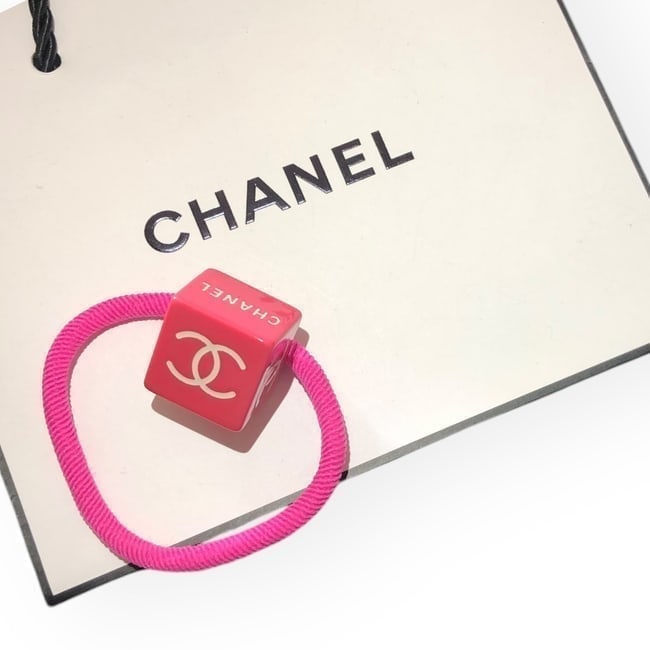 CHANEL Hot Pink/White Cube CC Hair Tie & Original Gift Bag: • CHANEL • L.A. Collection • Gabrielle • Hair Tie • Hot Pink • White CC Logo • Hot Pink Tie • Shape: Cube • Unopened/In Original Packaging • Origin
