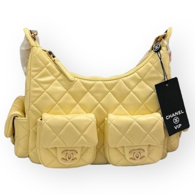 CHANEL Quilted Yellow Hobo Beaute Bag & Original Gift Bag: • CHANEL • Hobo • Yellow • Quilted Pattern • Gold Tone Hardware • Zip Closure • Chunky Chain Strap • 2 Exterior Front Pockets • 2 Exterior Side Pockets