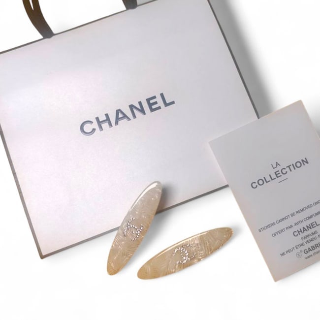 CHANEL 2Pc Lg White Shimmer/Rhinestone CC Beaute Hair Clips & Gift Bag: • CHANEL • 2Pc Set • Hair Clips • Gabrielle • L.A Collection • White Shimmer • Rhinestone CC • Gold Tone Hardware • Shape: Lg Long Skinny Oval • O