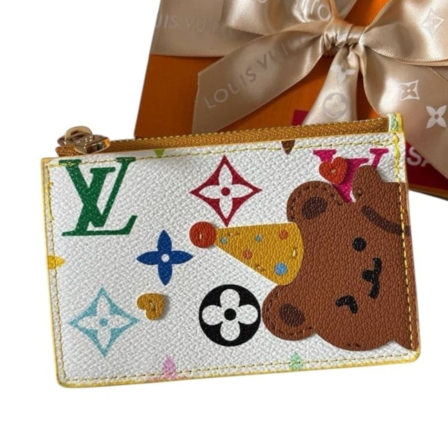 Louis Vuitton Happy Bear White Mono Beaute Card Holder & Original Box: • Louis Vuitton • Card Holder • White Multicolor Monogram Pattern • Happy Bear Themed • Zip Closure • Card Slots • Slip Pocket • Gold Tone Hardware •