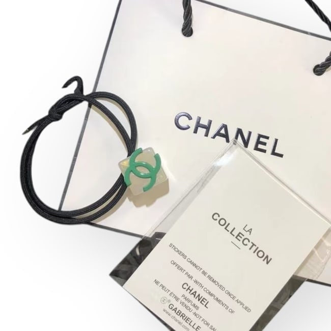 CHANEL Clear/Green Cube CC Logo Hair Tie & Original Gift Bag: • CHANEL • L.A. Collection • Gabrielle • Hair Tie • Clear • Green CC Logo • Tie Color: Black • Shape: Cube • Unopened/In Original Packaging • Origi