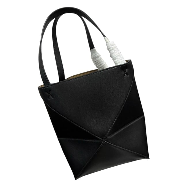 Loewe Black Mini Puzzle Fold Beaute Tote & Original Gift Bag: • Loewe • Mini Puzzle Fold • Tote • Black • Gold Tone Hardware • Front Logo • Double Handles • Open Top • Interior Color: Brown • 7.5" x 6.5" (in)