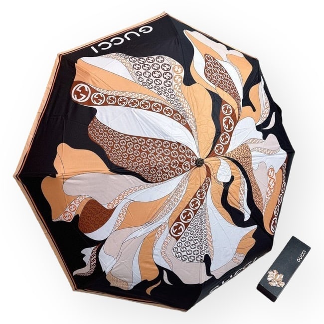 Gucci Brown Multicolored Beaute Umbrella, Sleeve, & Original Box: • Gucci • Umbrella • Brown • Multicolor Accents • Floral Pattern • Top Logo • Silver Tone Hardware • Handle Loop Making It Easy To Carry • Original Storage