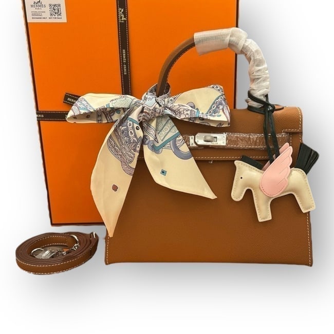 Hermes Kelly Brown/Silver 2Way Carry Beaute Bag & Original Box: • Hermes • Kelly • Birkin Bag • Silver Tone Hardware • Signature Front Twist Lock Closure • Removable Strap Included • Shoulder Carry • Top Handle For Optional