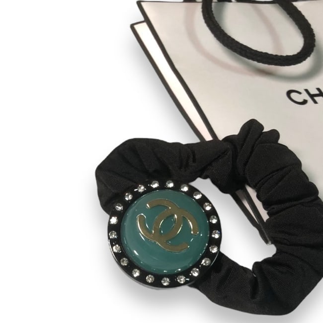 CHANEL Rhinestoned Round Emerald Green CC Hair Tie/Scrunchy & Gift Bag: • CHANEL • Black • Shape: Round • Emerald Green • White Rhinestone Accents • L.A Collection • Hair Tie/Scrunchy • Dark Olive CC Logo • Unopened/In Original