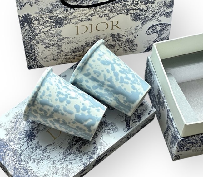 Christian Dior 2Pc Set White/Baby Blue Ceramic Ink-Splash Mugs & Original Box: • Christian Dior • Set Of 2 • Drinking Glasses • Ceramic Ink-Splash Mug • White • Baby Blue Detail • Original Box Included • 4.1" x 3" (in) • Discover the