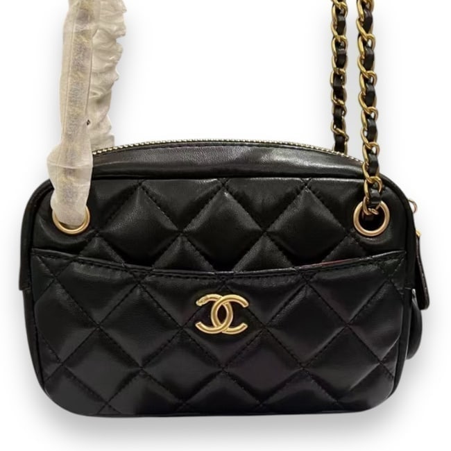 CHANEL Black Quilted Mini Camera Beaute Bag & Original Box: • CHANEL • Black • Quilted Pattern • Gold Tone Hardware • Burgundy Interior • Exterior Slip Pocket • Front CC Logo • Zip Closure • Internal Zip Pocket