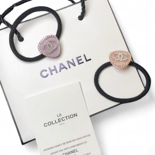 CHANEL 2Pc Purple & Pink/Rhinestone Accented Guitar Pick Hair Ties & Gift Bag: • CHANEL • 2Pc Set • L.A Collection • Hair Ties • Gabrielle • Color 1: Pink • Color 2: Purple • Rhinestone Trim • Shape: Guitar Pick • Rhinestone CC L