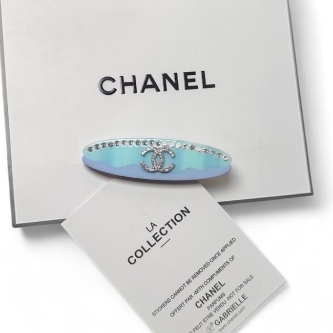 CHANEL Lg Blue Multicolor/Rhinestone Detailed Long Oval Hair Clip & Gift Bag: • CHANEL • Style: Gabrielle • Type: Hair Clip • Color: Blue Multicolored • Feature: Rhinestone Accents • Logo: Rhinestone CC Logo • Hardware: Gold Tone • Shape: