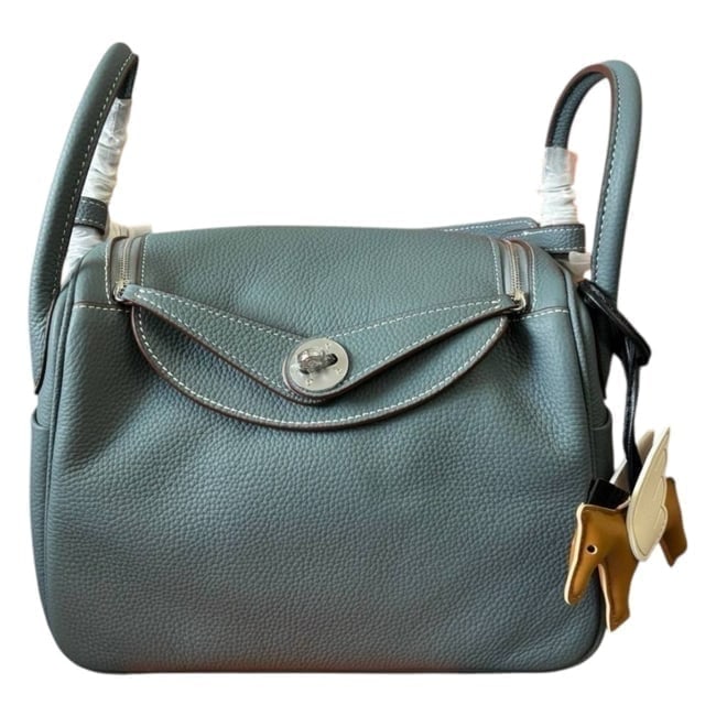 Hermes Lindy Blue/Silver Taurillon Pattern Beaute Bag & Original Box: • Hermes • Blue • Taurillon Pattern • Lindy • Signature Front Twist Closure • Silver Tone Hardware • Zip Closure On Sides • Interior Slip Pocket • Si