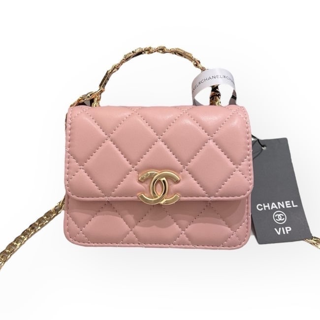 CHANEL Pink Quilted Mini 2Way Carry Beaute Bag & Original Box: • CHANEL • Pink • Quilted Pattern • Gold Tone Hardware • Single Chain Link Strap • Chain Link COCO Logo Top Handle • Front CC Logo • Magnetic Snap Closure &bull