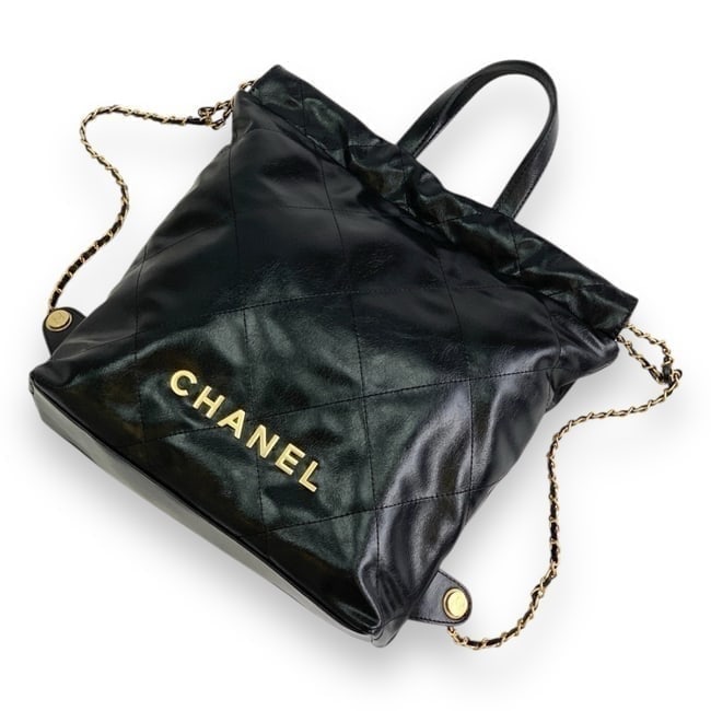 CHANEL Lg Quilted 2Way Carry Beaute Backpack & Original Gift Bag: • CHANEL • Black • Quilted Pattern • Gold Tone Hardware • 2 Way Carry Backpack • Top Handle or Shoulder Carry • Front CHANEL Logo • Magnetic Closure • 13.4