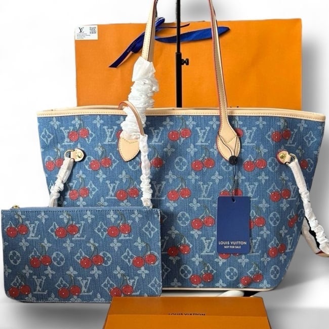 Louis Vuitton Denim/Cherry Accented Neverfull MM Beaute Bag & Removable Pouch: • Louis Vuitton • Neverfull MM • Denim • Gold Tone Hardware • Monogram Pattern • Cherry Accented • Interior: Denim • Double Handles • Interior Zip Pocket <