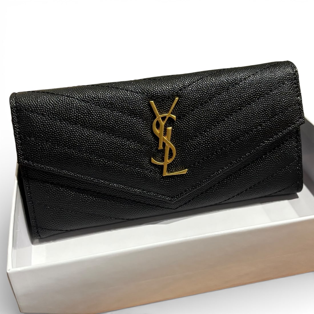 YSL (Saint Laurent) Black/Gold Chevron Front Logo Beaute Wallet & Original Box: • YSL (Saint Laurent) • Long Wallet • Chevron Print • Black • Gold Tone Hardware • Snap Closure • Front Logo • Interior Zip Pocket • Card Slots •
