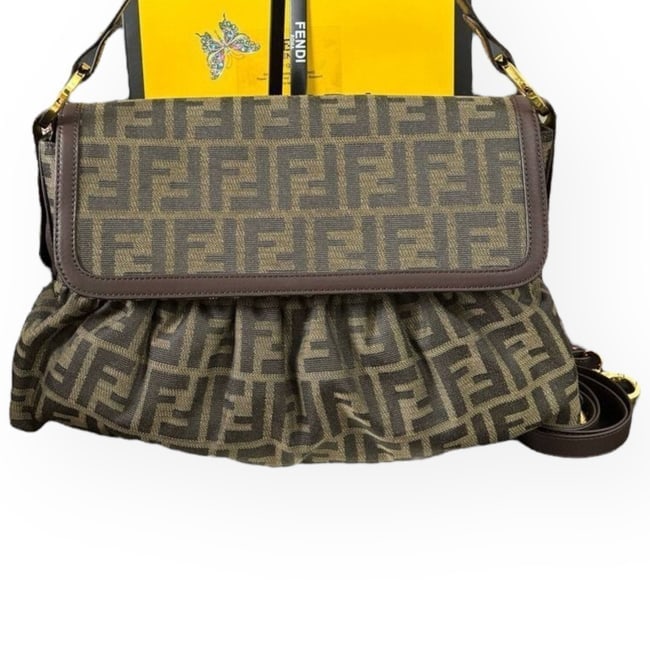 Fendi Zucca Chef Beaute Bag & Original Gift Bag: • Fendi • Chef • Baguette • Signature Zucca Pattern • Gold Tone Hardware • Interior Zip Pocket • Single Strap • Flap Closure • Brown Trim • Should